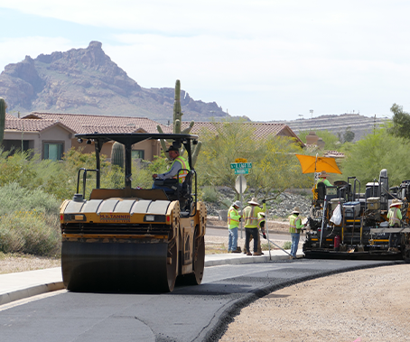 Rollers compacting asphalt on road