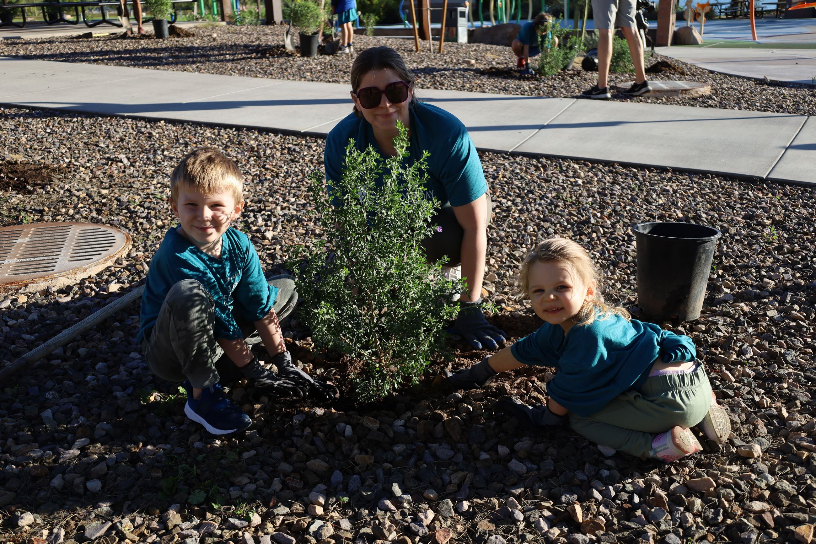 two kids and parent landscaping
